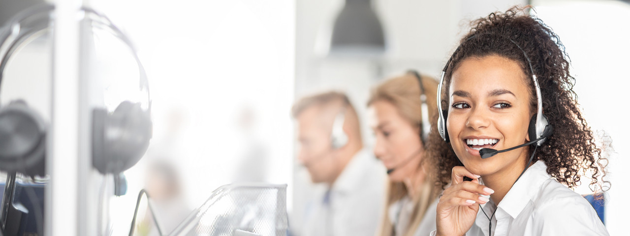 header-adobe-stock-call-center-worker-accompanied-by-her-team